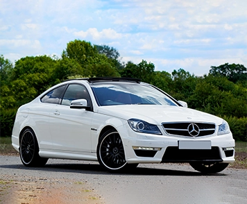 A white Benz car offers luxury and performance, perfect for those seeking a premium ride experience.