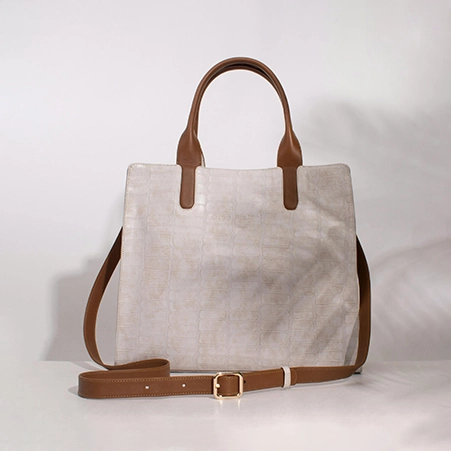 Unedited stylish branded handbag image to be enhanced with background removal and retouching.